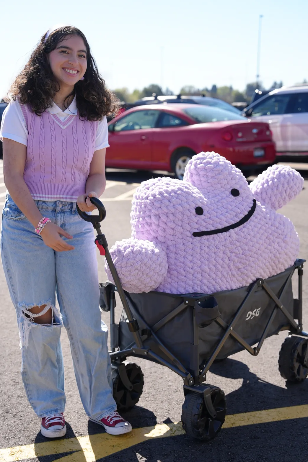 Maya with a giant handmade crochet cloud in a wagon